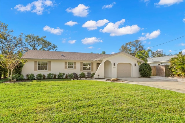 ranch-style house featuring a front yard and a garage