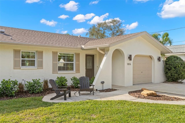 view of front of house with a garage and a front lawn