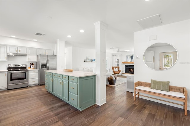 kitchen with green cabinets, white cabinetry, ceiling fan, and appliances with stainless steel finishes