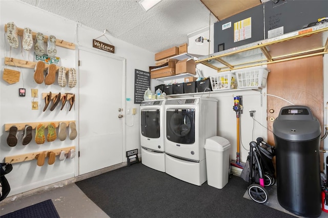 laundry area with a textured ceiling and washer and clothes dryer