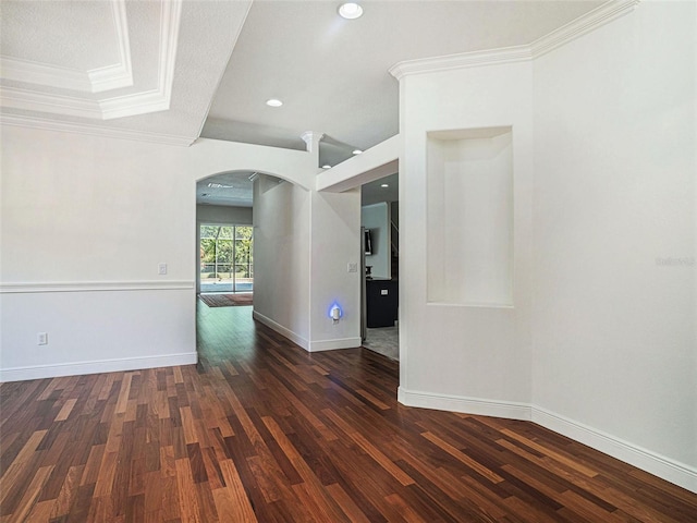 empty room featuring dark hardwood / wood-style flooring and crown molding