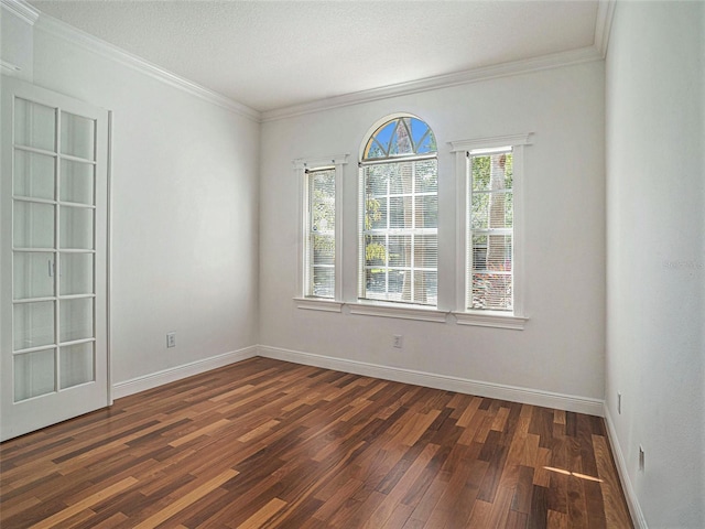 unfurnished room featuring ornamental molding and dark wood-type flooring