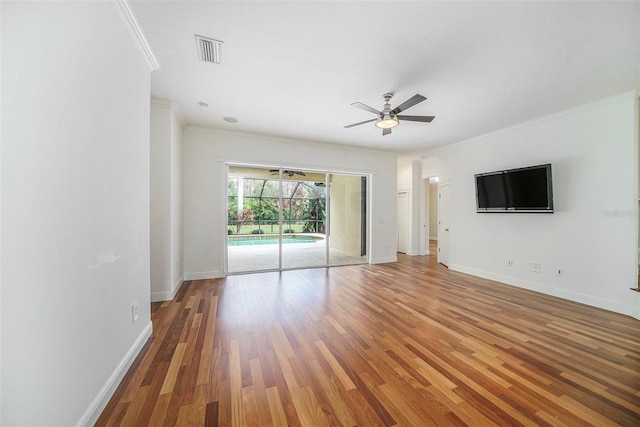 unfurnished living room featuring hardwood / wood-style floors, ceiling fan, and crown molding