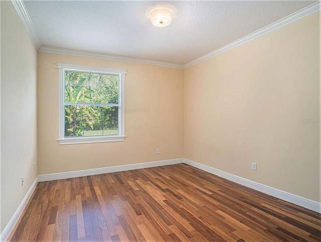 spare room featuring wood-type flooring and crown molding