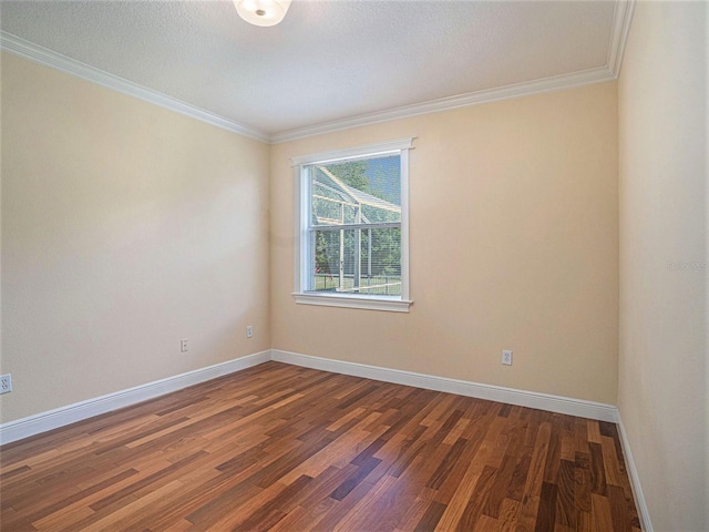 empty room with crown molding and dark wood-type flooring