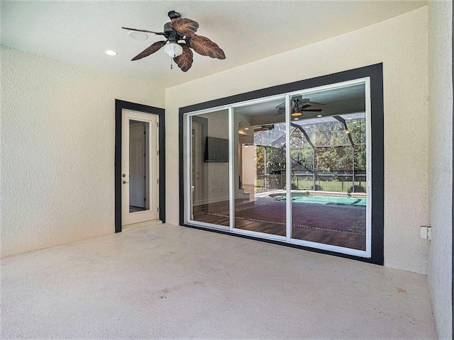 view of patio / terrace with ceiling fan and a lanai