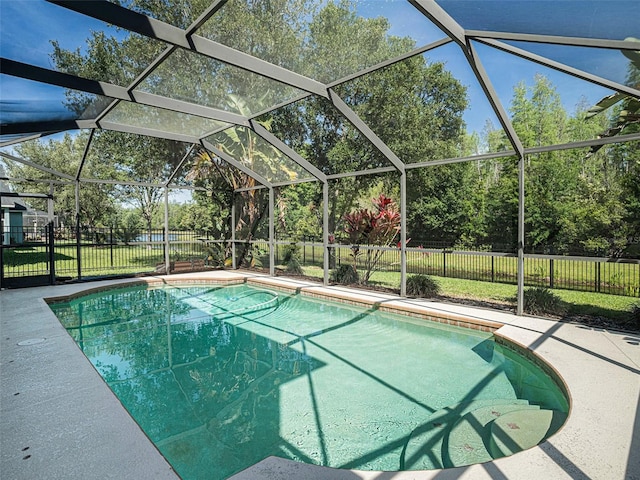 view of swimming pool featuring a lanai and a yard