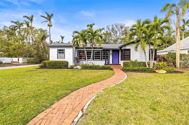 single story home featuring a front yard