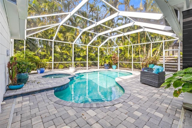 view of swimming pool with an in ground hot tub, a patio, and glass enclosure