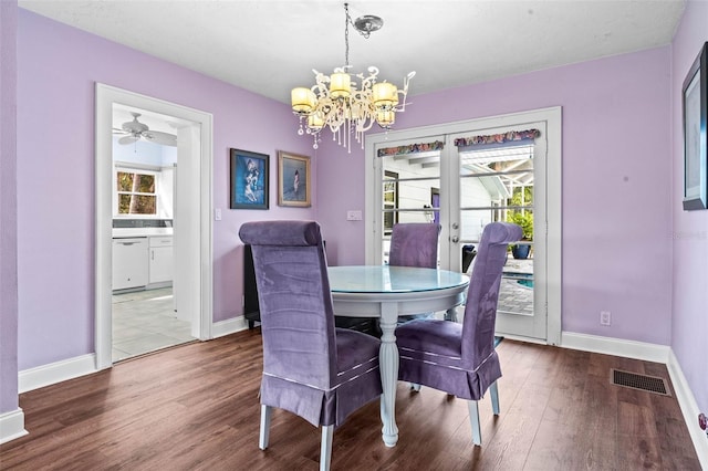 dining space with french doors, light hardwood / wood-style floors, and ceiling fan with notable chandelier