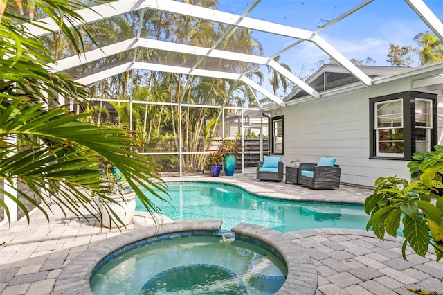 view of pool with a lanai, a patio area, and an in ground hot tub