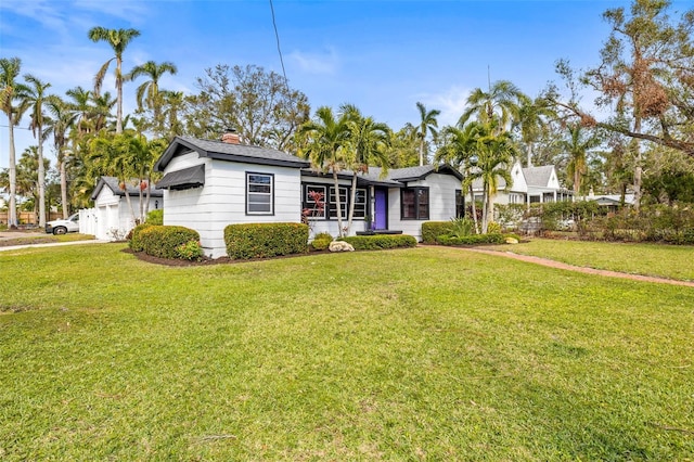 ranch-style home with a front lawn