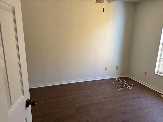 empty room featuring ceiling fan and dark wood-type flooring