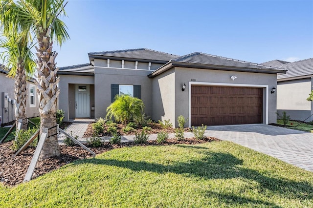 view of front of home with a front yard and a garage