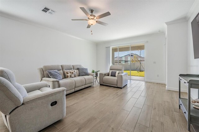 living room with crown molding and ceiling fan