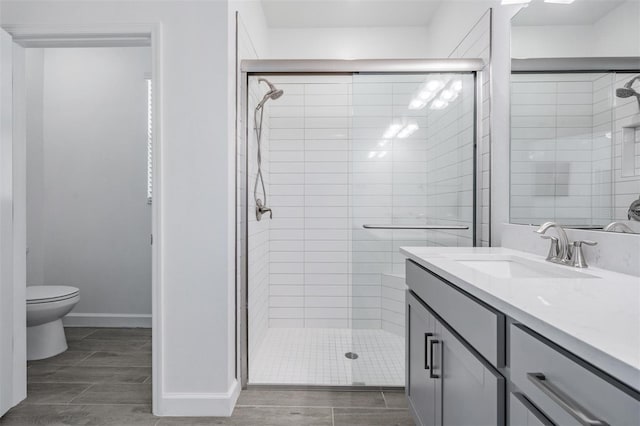 bathroom featuring vanity, toilet, and walk in shower