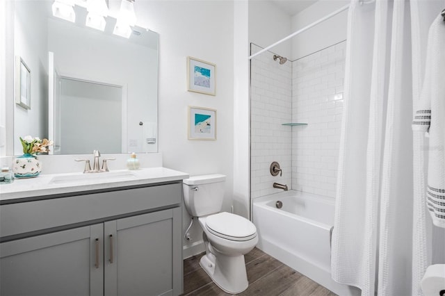 full bathroom featuring shower / bath combo with shower curtain, vanity, wood-type flooring, and toilet