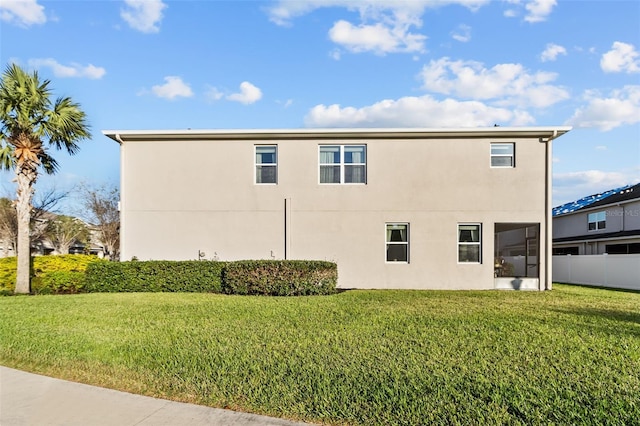 view of side of home with a yard