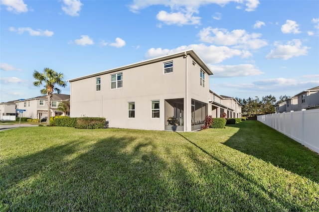 back of house with a lawn