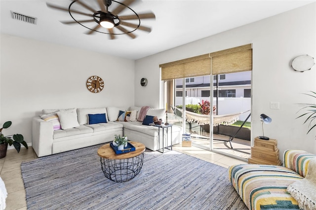 tiled living room with ceiling fan