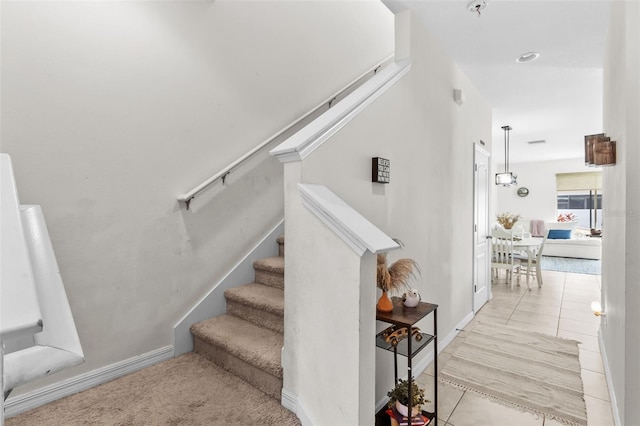 staircase featuring tile patterned floors