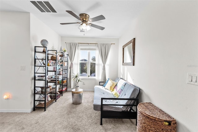 living area featuring light carpet and ceiling fan