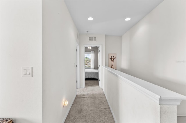 hallway featuring light colored carpet