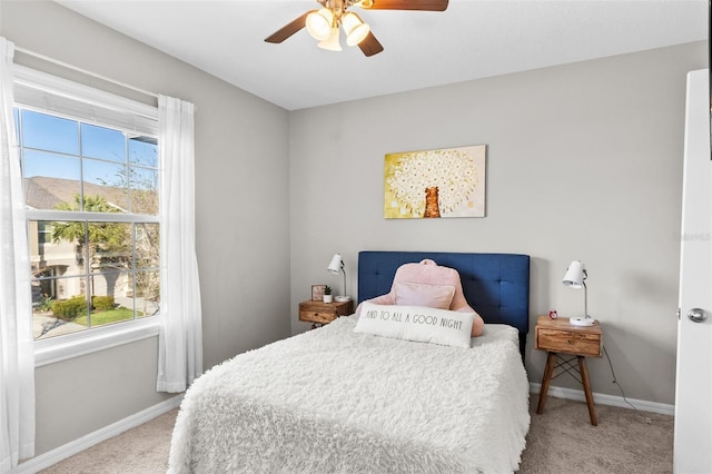 bedroom featuring ceiling fan and light carpet