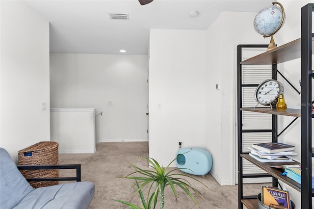 living area featuring light colored carpet