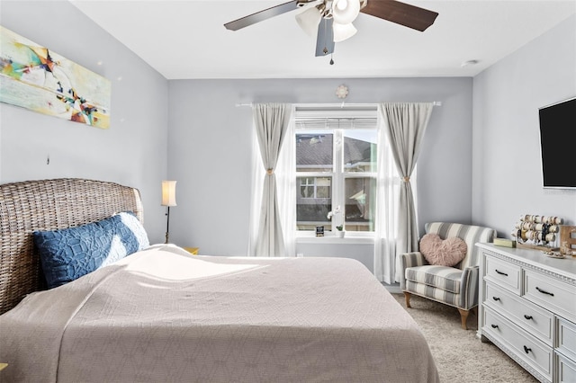 bedroom with light carpet and ceiling fan