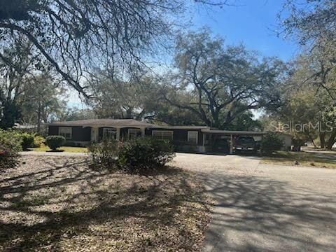 ranch-style home featuring a carport