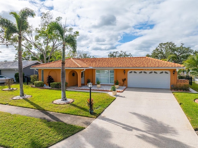 view of front of house with a garage and a front lawn