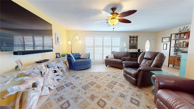 living room with ceiling fan and light tile patterned floors