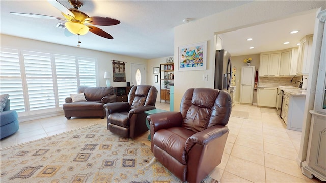 living room with ceiling fan and light tile patterned floors