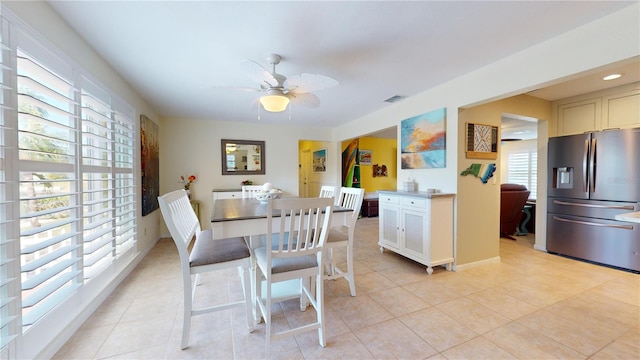 dining space featuring ceiling fan and light tile patterned floors