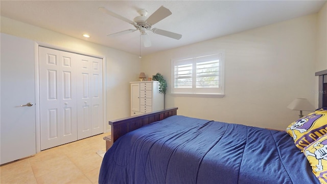 bedroom featuring ceiling fan, light tile patterned floors, and a closet