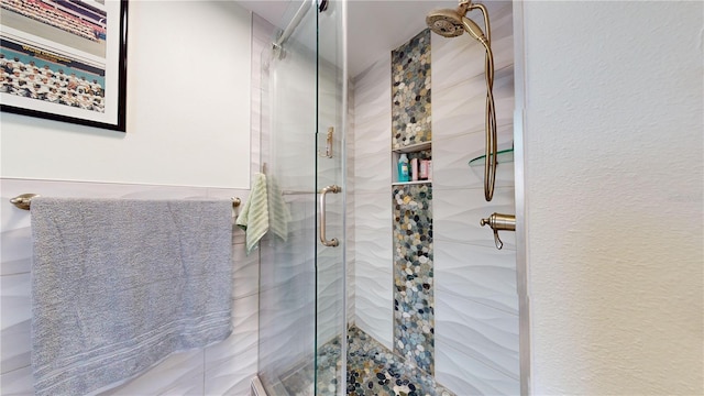 bathroom featuring a shower with shower door