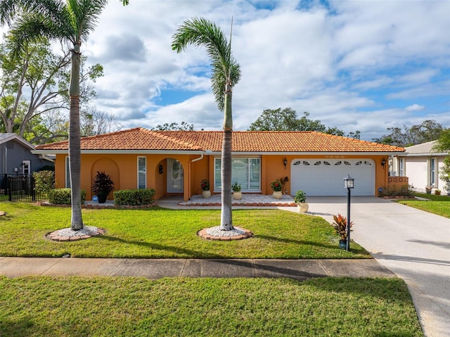 view of front of home featuring a front lawn and a garage