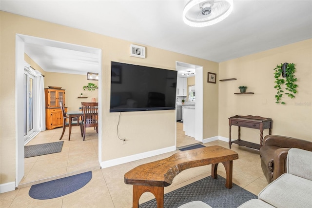 tiled living room with ceiling fan