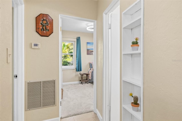 hallway featuring light carpet