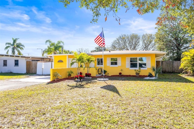 ranch-style home with a front lawn