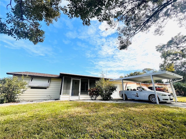 view of front of property with a front lawn and a carport