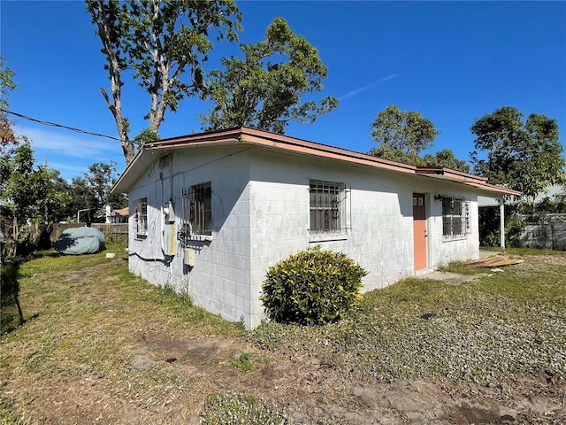 view of property exterior with a yard