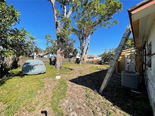 view of yard featuring central air condition unit