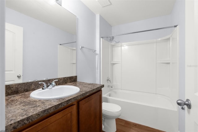 full bathroom with bathtub / shower combination, wood-type flooring, vanity, and toilet