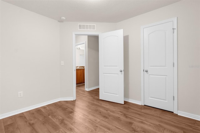 unfurnished bedroom featuring light wood-type flooring