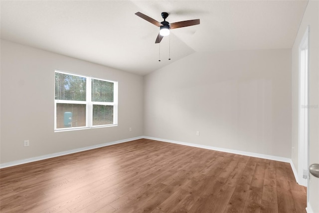 spare room featuring ceiling fan, wood-type flooring, and lofted ceiling