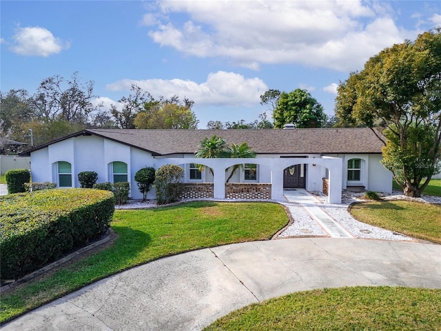 ranch-style home featuring a front yard