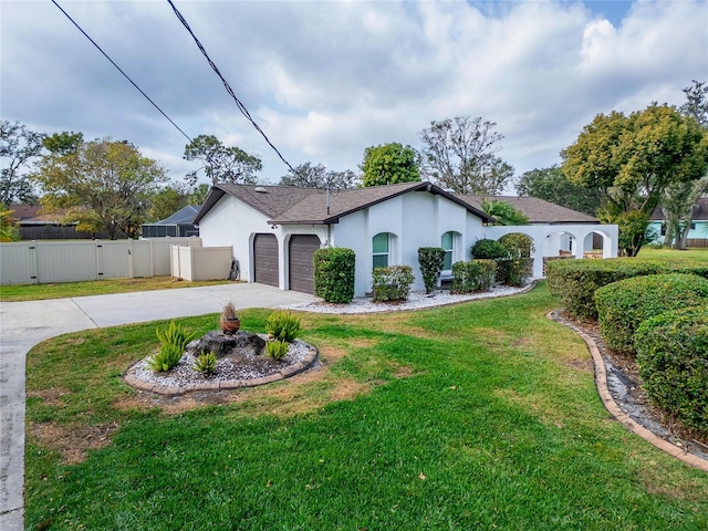 view of front of property with a garage and a front yard