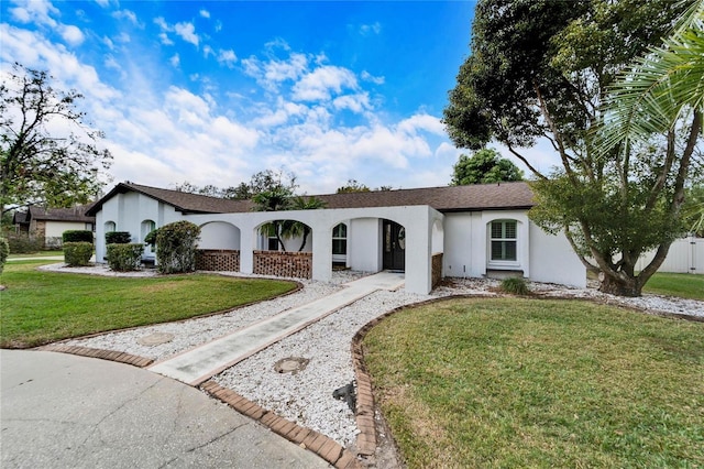 single story home featuring a front yard